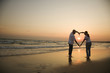 Couple on beach at sunset.