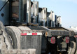 rear view of a fleet of parked semi tractors