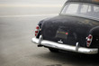 rusted black automobile from behind rusted black automobile from behind