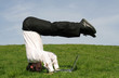 businessman upside down using laptop