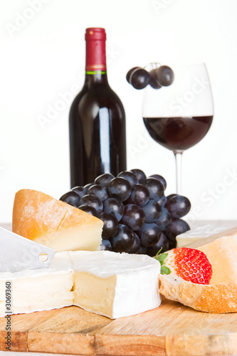 Photo: a cheese selection with a bottle of wine a cheese selection with a bottle of wine