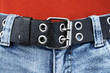 black leather belt and blue jeans