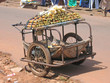 small rural car with two wheels parked in the street to sell sug
