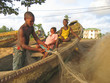 young african childrens on a typical boat coming back from fishi