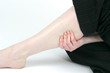 woman holding sore leg muscle