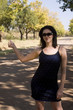 hitching brunette with sunglasses