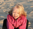 cute little girl playing at the beach