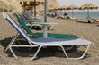 beach with sun shades and empty beach chairs