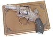 antique book and gun (cocked)