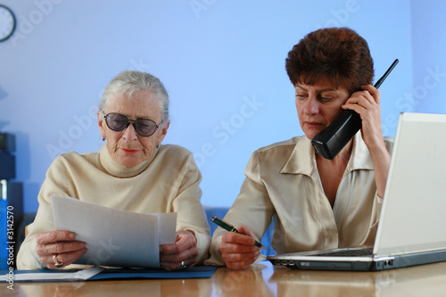 Photo: social worker helping senior woman social worker helping senior woman