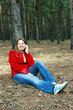 girl talk for phone sitting under tree