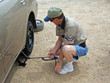 man changing tire