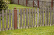 weathered fence and green grass