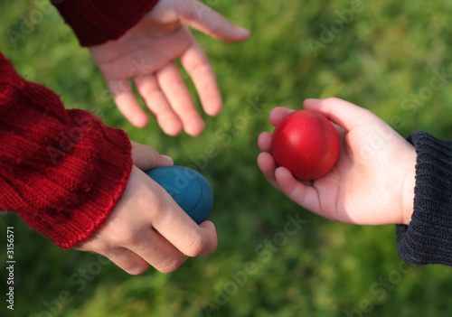 Photo: Children're giving each other easter eggs Children're giving each other easter eggs