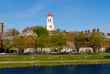 harvard university students relaxing along charles