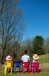 girls sitting together looking away to the woods