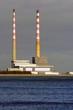 two big factory pipes by the sea