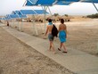 couple/tourists holding hands going to the beach.