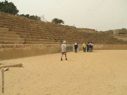 tourists in the old roman theatre in caesarea