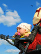 baby in a carriage on blue sky background