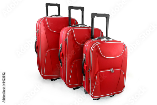 Three red travel suitcases (trolley) - isolated