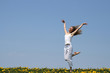 smiling girl dancing in dandelion field