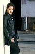 Attractive young woman posing leaning against a wall Attractive young woman posing leaning against a wall