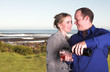 couple next to the coast drinking wine