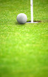 golf ball close to hole