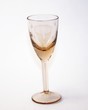 wine-glass of yellow glass in a coaster