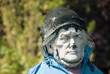 old ancient stone statue used as a scarecrow 03 old ancient stone statue used as a scarecrow 03