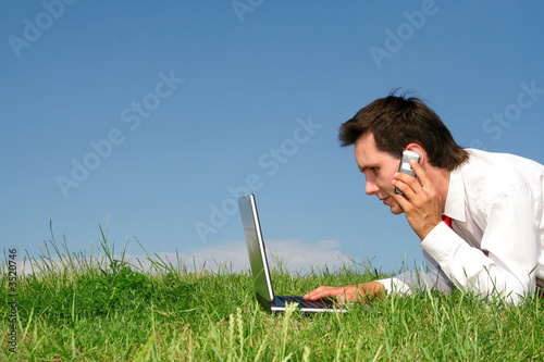 businessman working on laptop outdoors