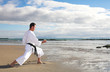 Man practicing Karate on the beach