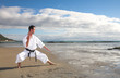 Man practicing Karate on the beach
