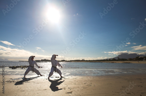 Photo: Man practicing Karate on the beach Man practicing Karate on the beach
