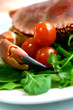 Freshly steamed crab served on fresh green salad and tomatoes