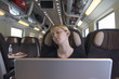 Young American woman takes a nap aboard a train in Italy.