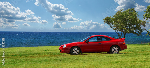 Photo: Red Sport Car parked on Fantastic Coast Red Sport Car parked on Fantastic Coast