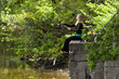 Pretty blond, barefoot woman fishing 