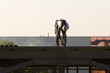 Construction welder on the roof of a building 