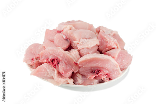 Photo: raw sliced chicken on plate isolated on white raw sliced chicken on plate isolated on white