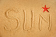 Sun writing on sand and red star