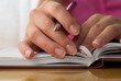Nice hands with french manicure on the notebook.