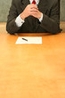 Business-man waiting at the desk, thinking over document.