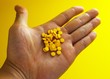 Handful of yellow tablets Handful of yellow tablets