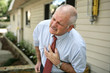 businessman doubled over clutching his chest businessman doubled over clutching his chest