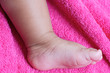 a baby foot a over color pink background