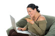 Nice brunnete working on laptop and eating a pizza