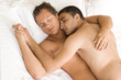 A homosexual couple sleeping in the bed