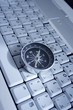 magnetic compass on a laptop, business travel concept